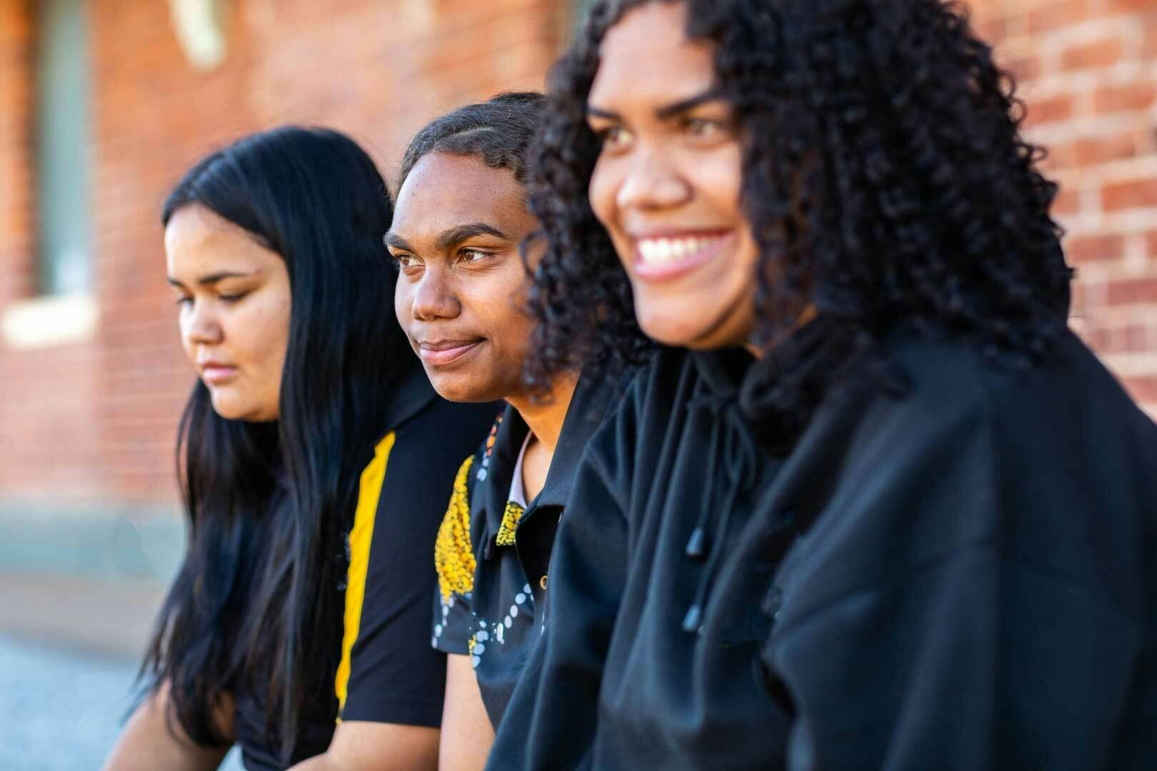 Austock000141679 three young Aboriginal women on campus