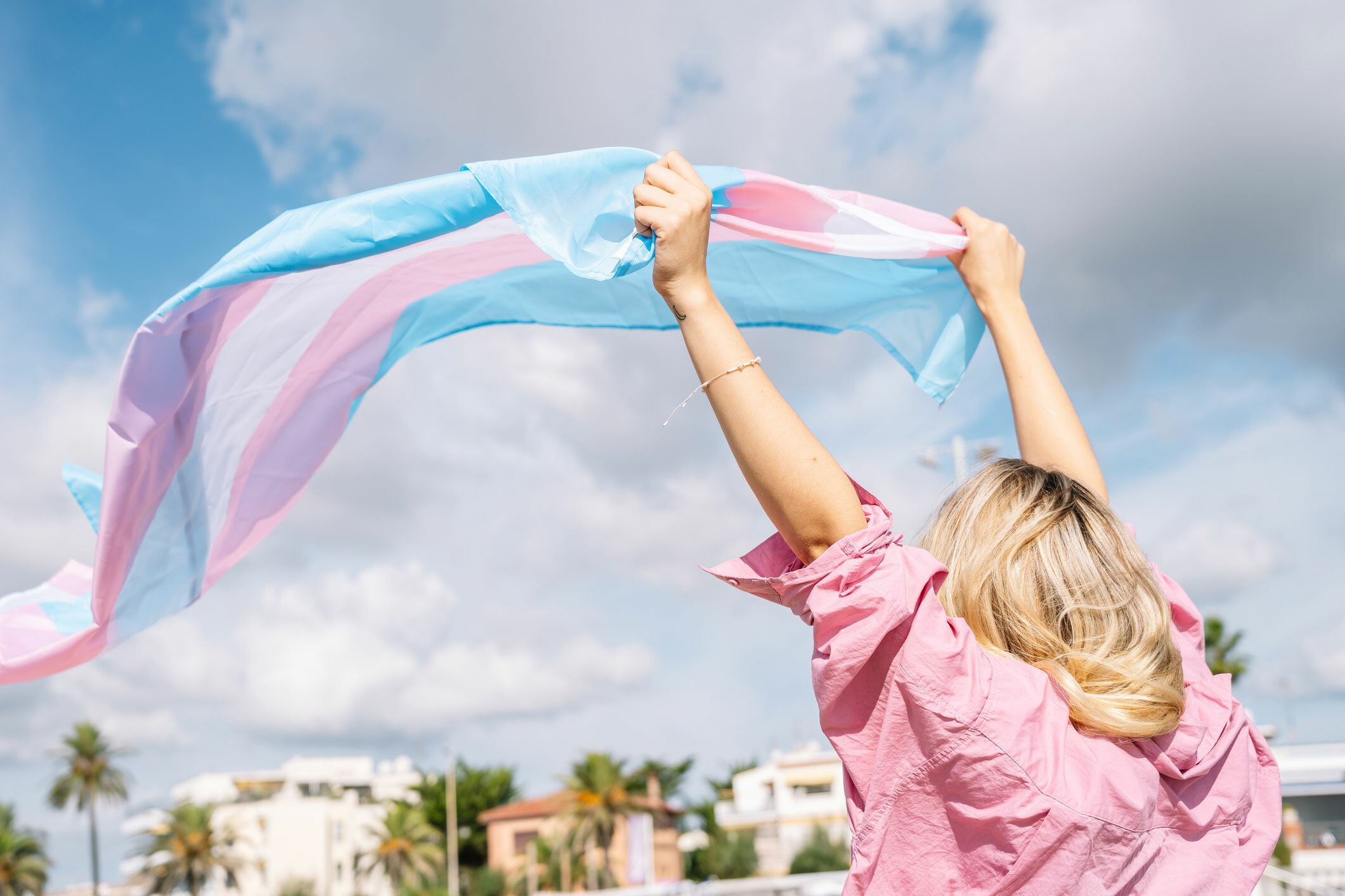 Person waving trans flag LGBTIQA