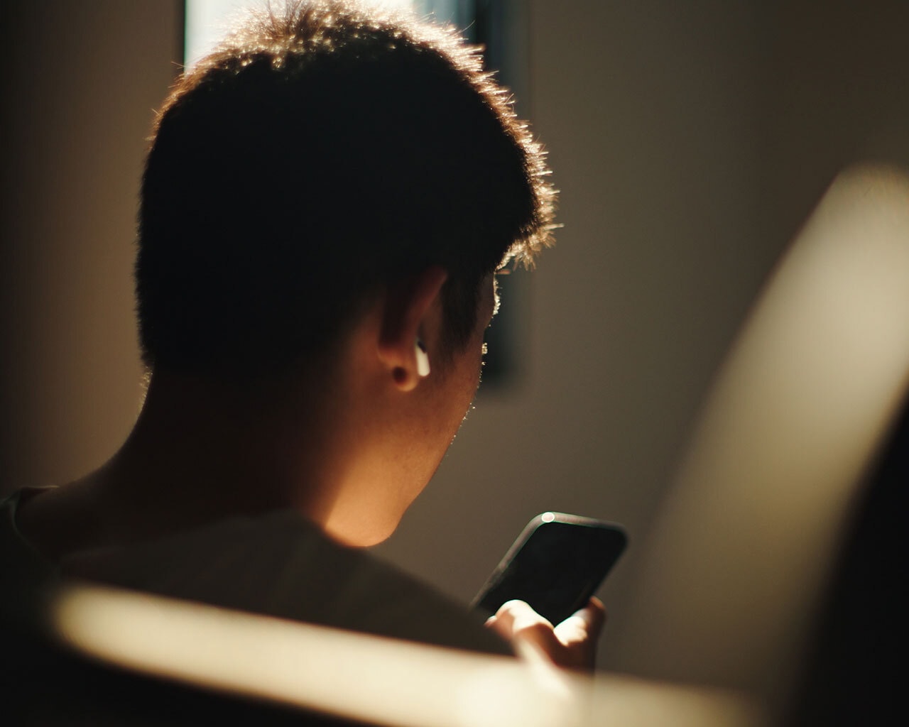 Teen boy on phone alone